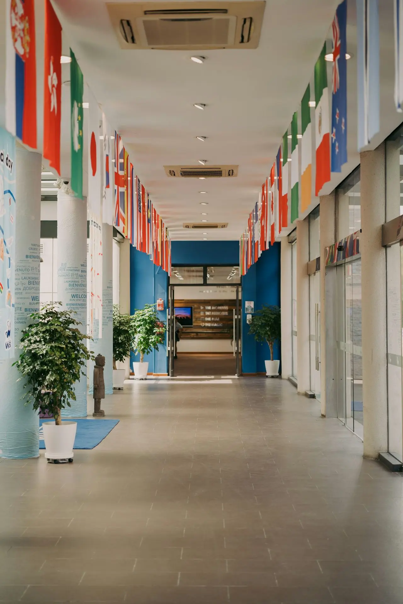 A hallway is decorated with international flags.